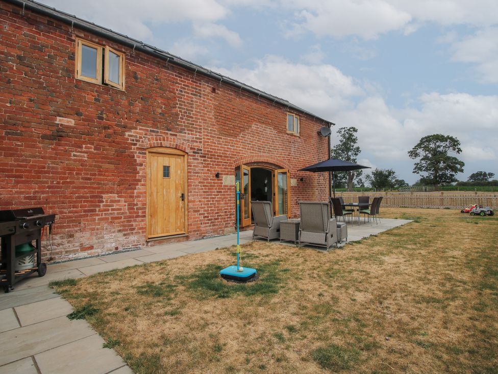An outdoor area with a table and chairs at Willow Barn Northwood near Wem