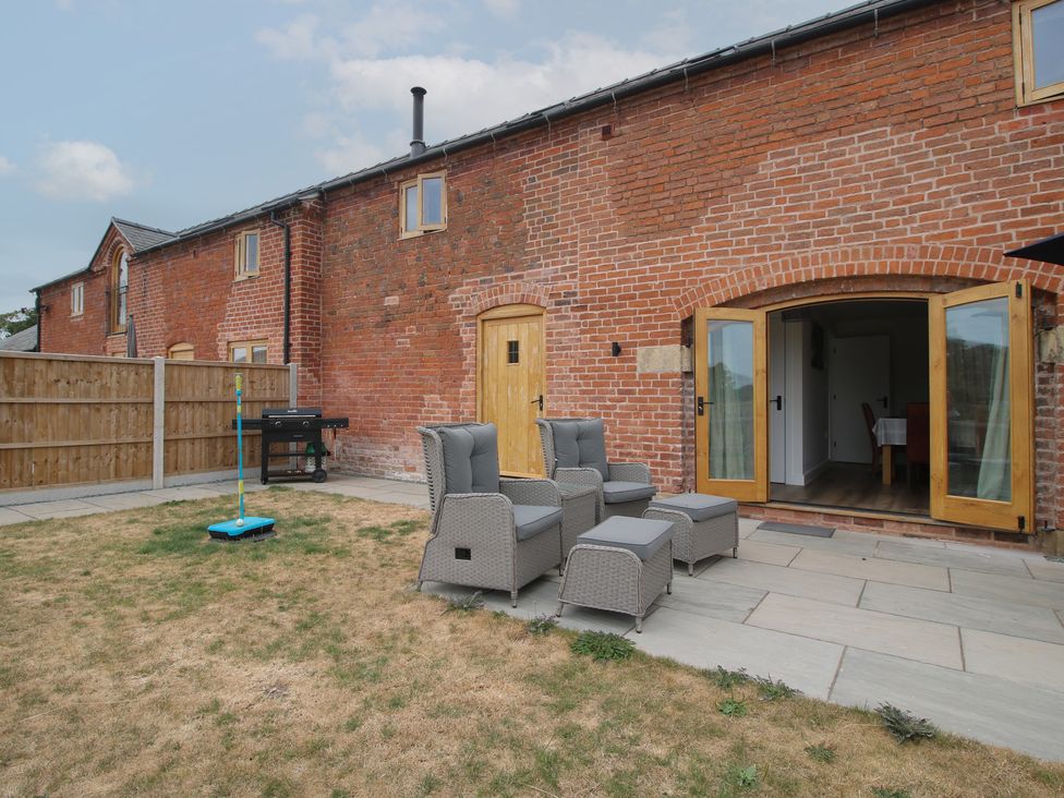 An outdoor area with furniture and grill at Willow Barn in Northwood near Wem