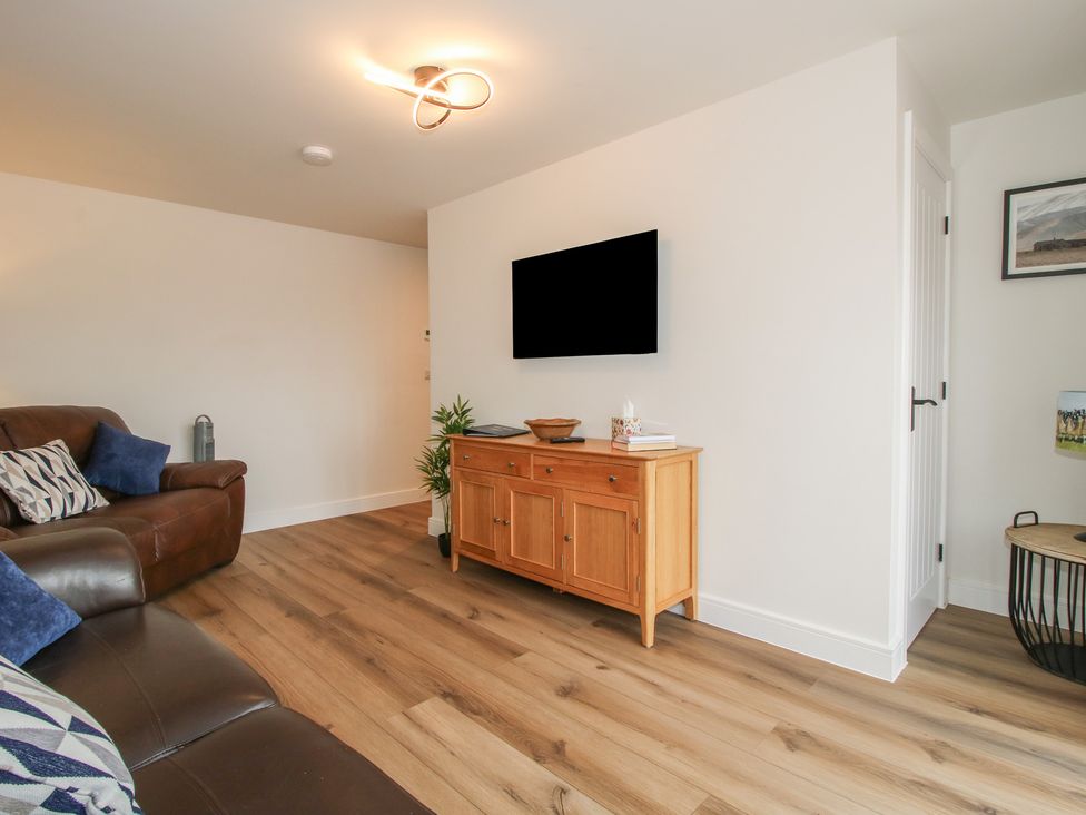 A living room with a television and a sofa at Elm Barn Northwood near Wem