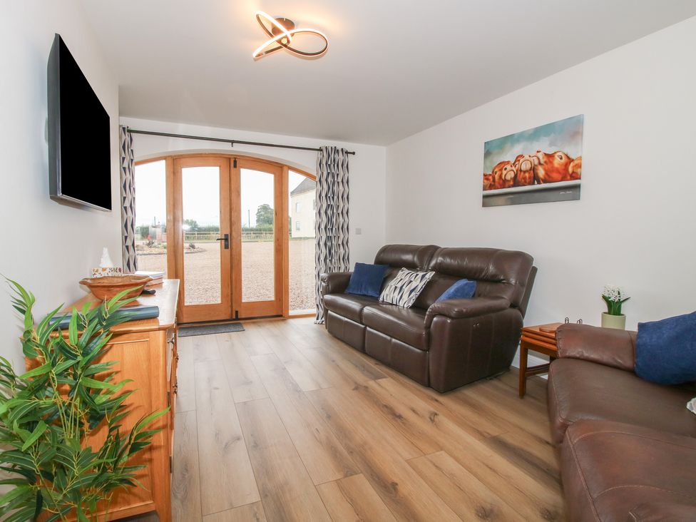 A living room with a sofa and a television at Elm Barn in Northwood near Wem