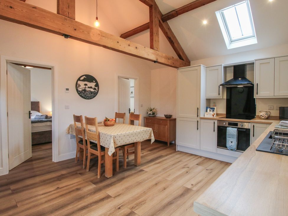 A kitchen with a dining table and chairs at Elm Barn Northwood near Wem