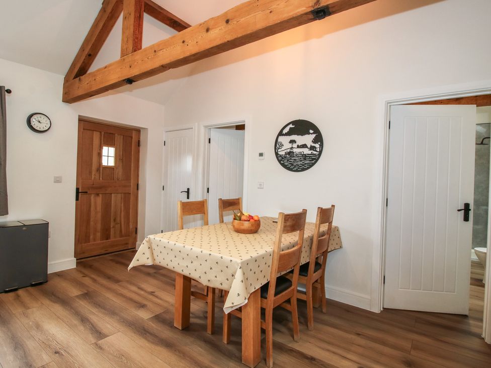 A dining room with a table and chairs at Elm Barn Northwood near Wem