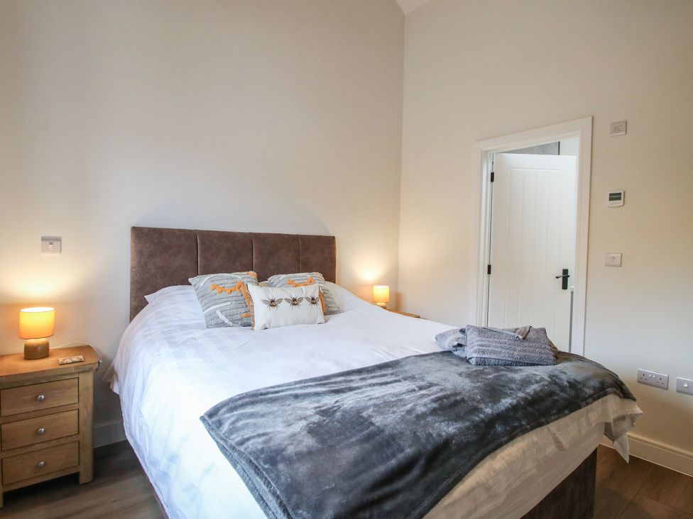 A bedroom with a bed and bedside lamps at Elm Barn Northwood near Wem
