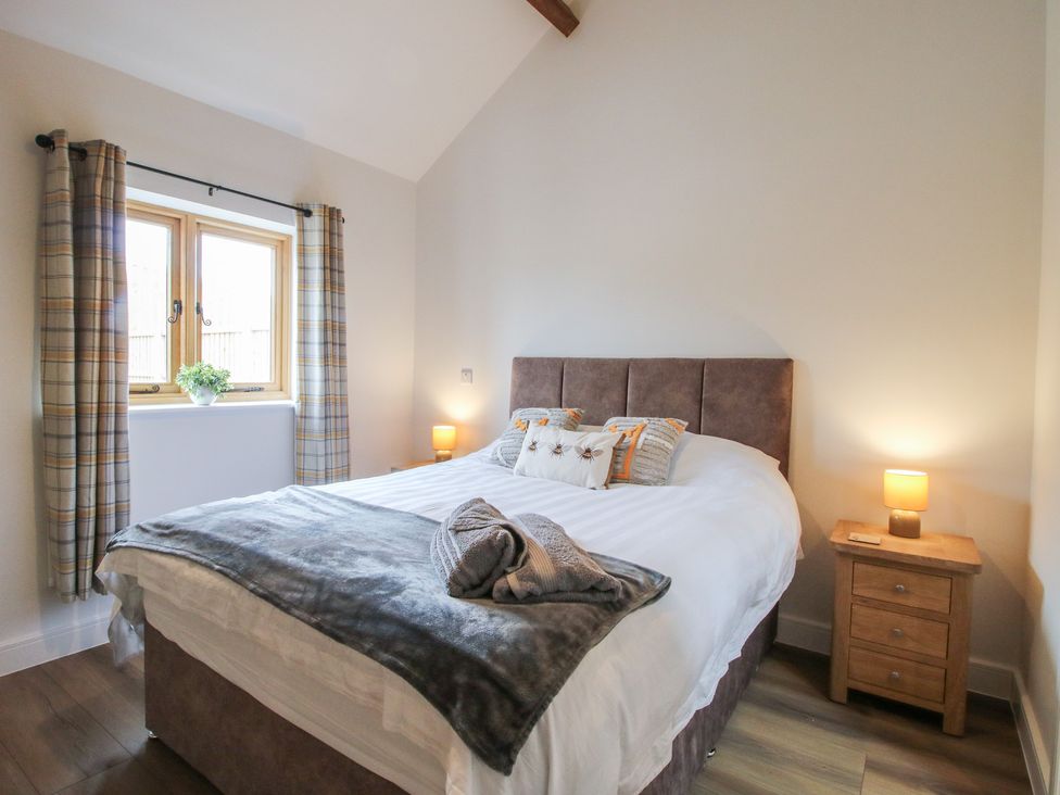 A bedroom with a bed and window at Elm Barn Northwood near Wem