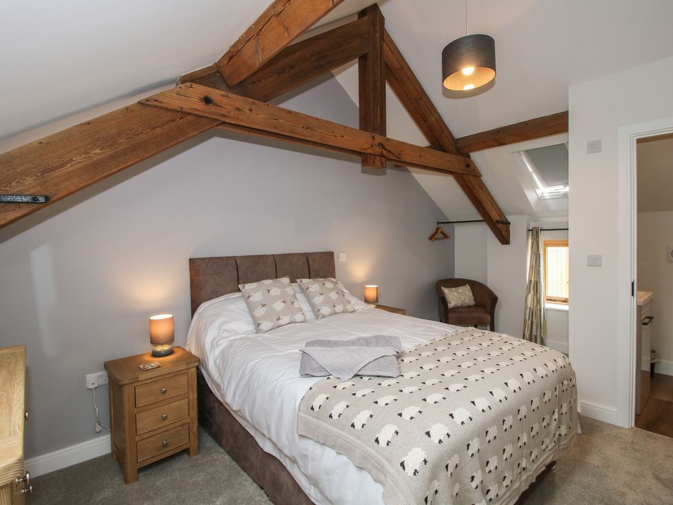 A bedroom with a bed and bedside table at Elm Barn Northwood near Wem