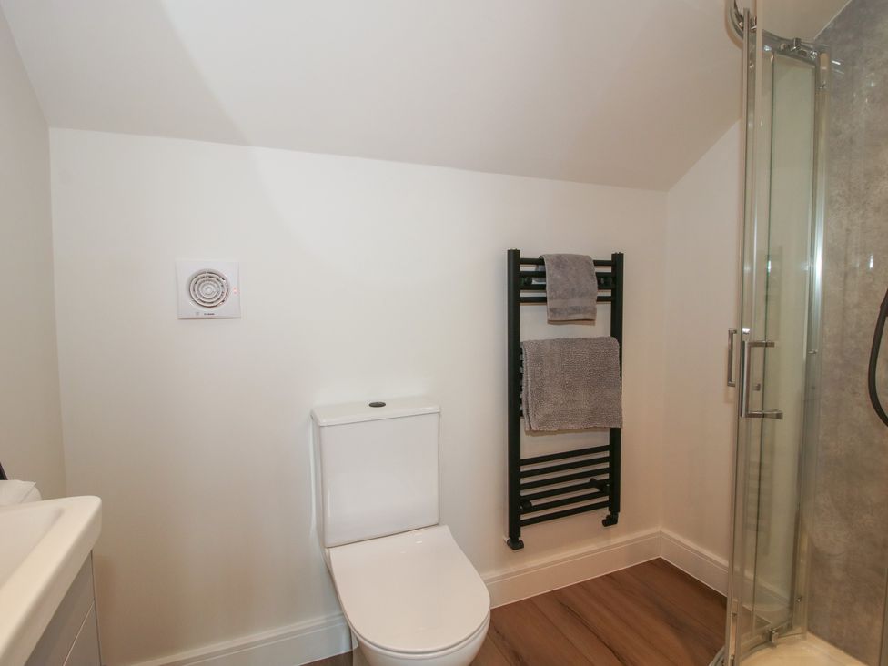 A bathroom with a toilet and towel radiator at Elm Barn Northwood near Wem