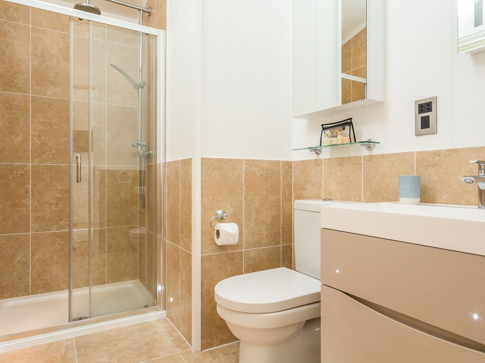 A bathroom with a shower and toilet at 2 Tree Tops, Lanreath
