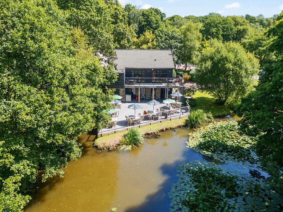 A house with a balcony by a river at 2 Tree Tops Lanreath