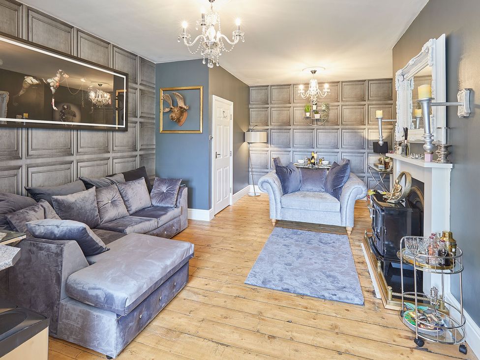A living room with a sofa and armchair at Apartment 2 in Whitby