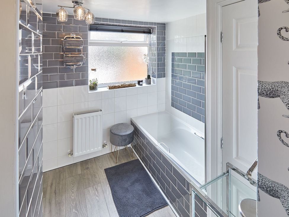 A bathroom with a bathtub and sink at Apartment 2 in Whitby