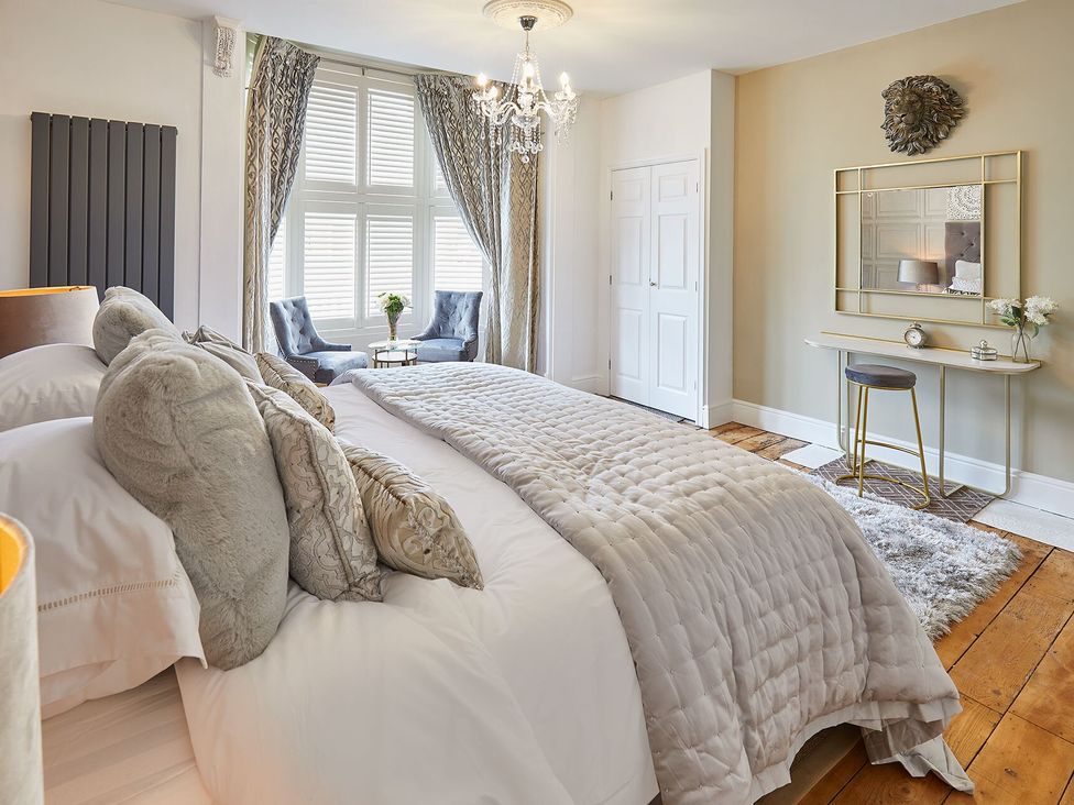 A bedroom with a bed and seating area at Apartment 2 in Whitby