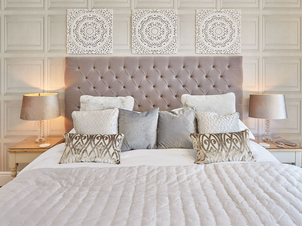 A bedroom with a bed and decorative items at Apartment 2 in Whitby