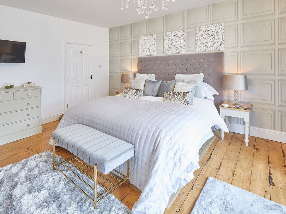 A bedroom with a bed and bedside tables at Apartment 2 in Whitby