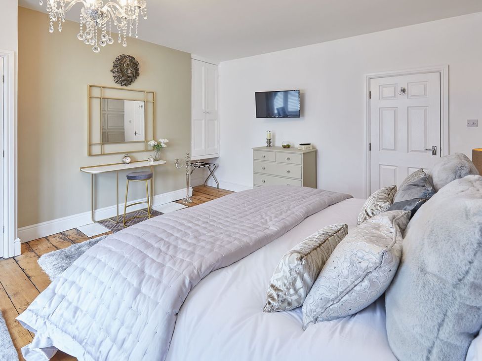 A bedroom with a bed and dresser at Apartment 2 in Whitby