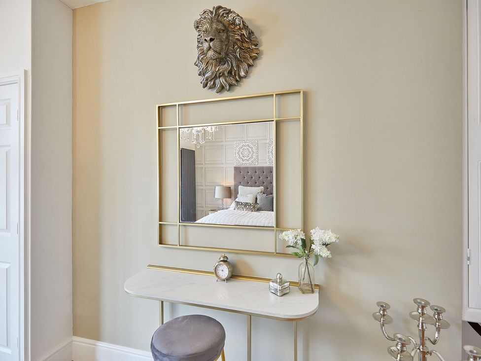 A hallway with a mirror and console table at Apartment 2 in Whitby