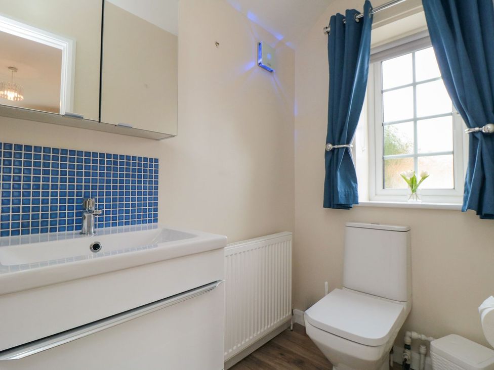 A bathroom with sink and toilet at Midsummer Cottage in Malton