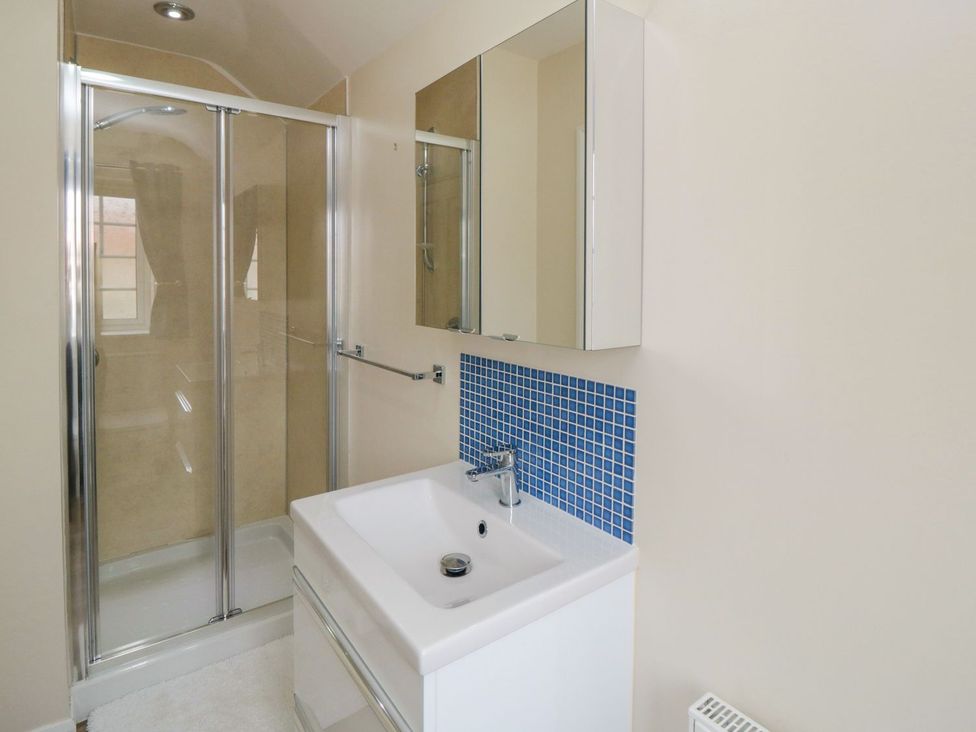 A bathroom with a shower and sink at Midsummer Cottage in Malton