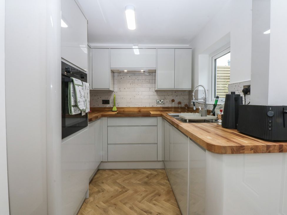 A kitchen with modern cabinets and appliances at Ty Gelert in Conwy