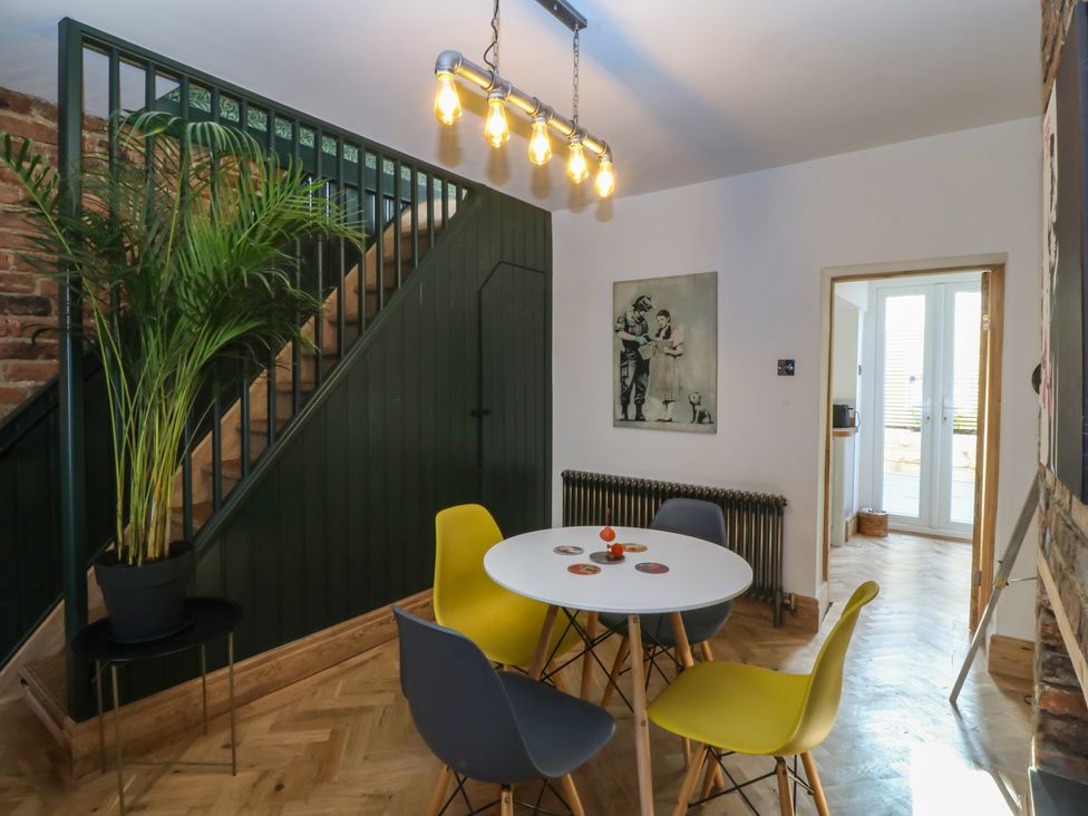 A dining area with a table and chairs at Ty Gelert in Conwy