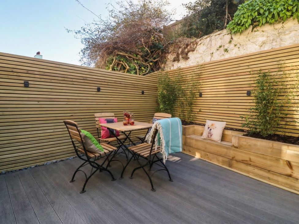 A patio with a table and chairs at Ty Gelert in Conwy