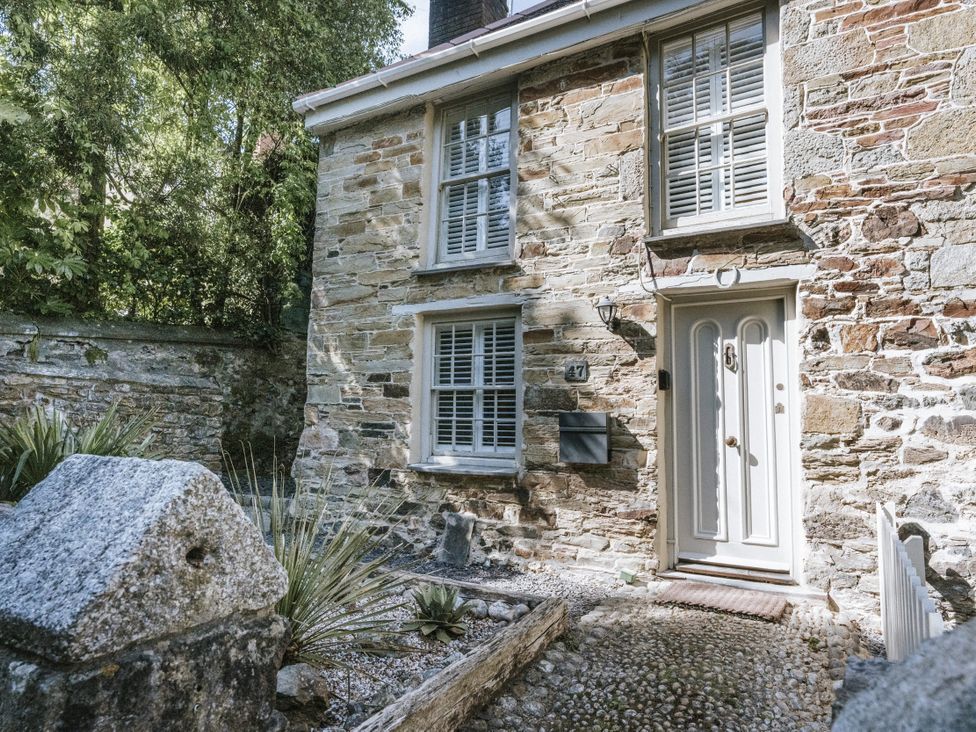 A house exterior with a door, windows, and plants at Tamarisk Cottage in St. Agnes