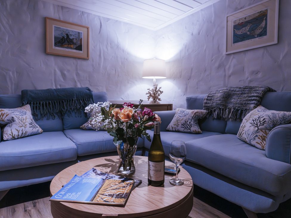 A living room with a sofa and coffee table at Tamarisk Cottage in St. Agnes
