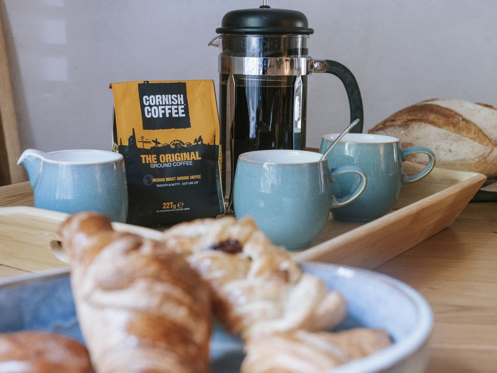 A kitchen with coffee and pastries at Tamarisk Cottage in St. Agnes