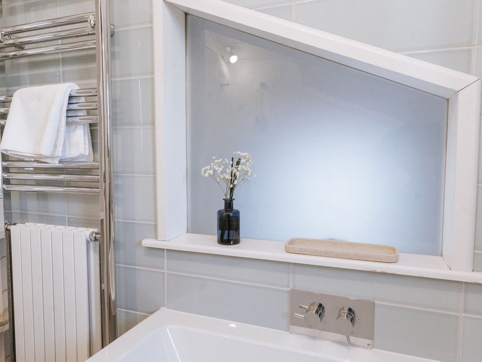 A bathroom featuring a bathtub and a towel rail at Tamarisk Cottage in St. Agnes