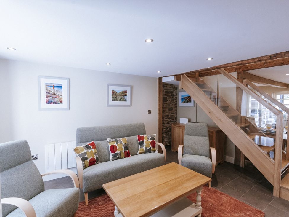 A living room with furniture and a staircase at Bluck's cottage St. Agnes
