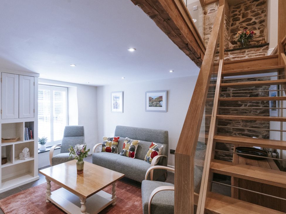 A living room with a sofa and coffee table at Bluck's cottage in St. Agnes