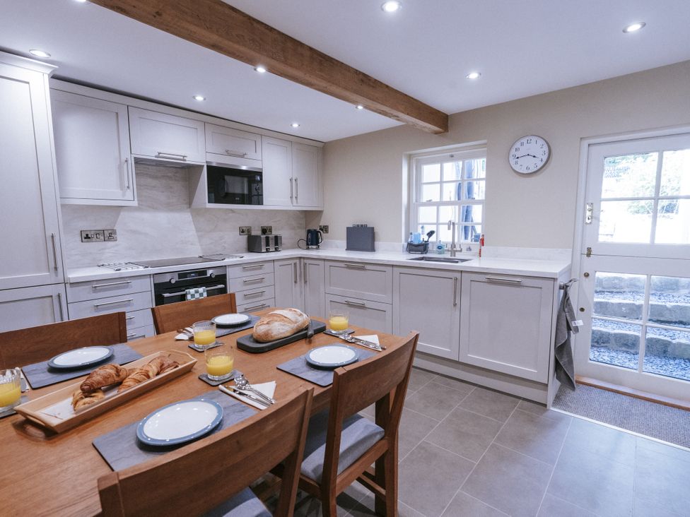 A kitchen with table and breakfast items at Bluck's cottage in St. Agnes