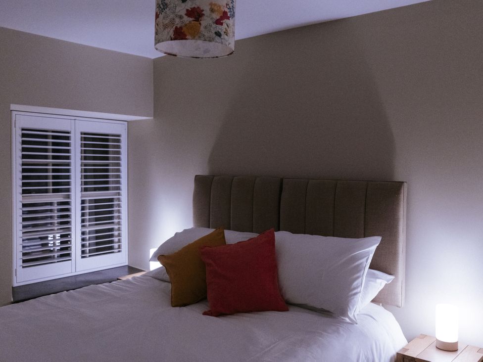 A bedroom with a bed and bedside lamp at Bluck's cottage St. Agnes