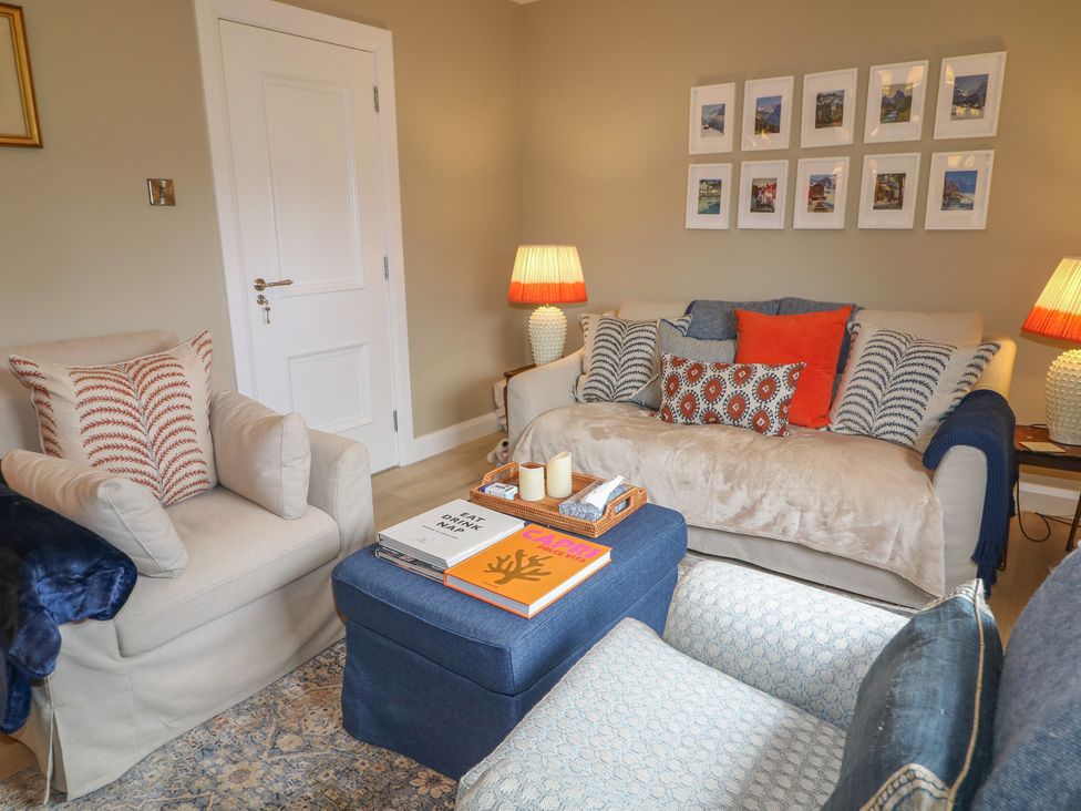 A living room with a sofa and armchair at Clarmes House in Limavady