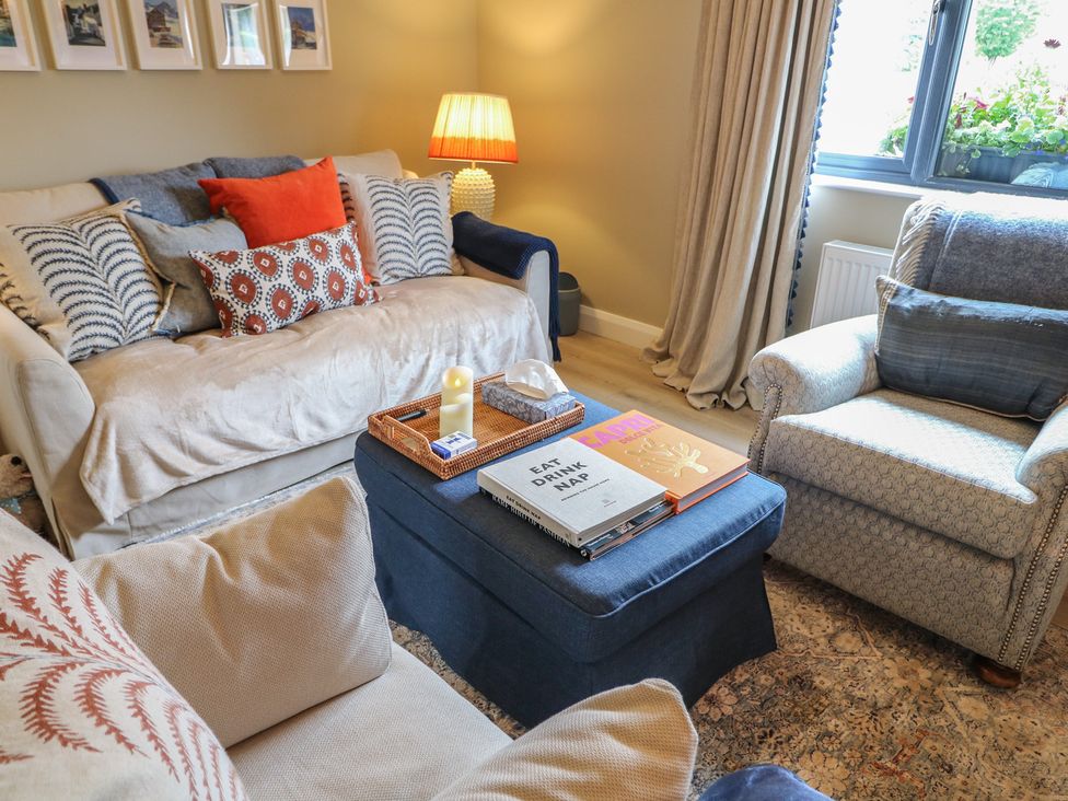 A living room with a sofa and an armchair at Clarmes House in Limavady