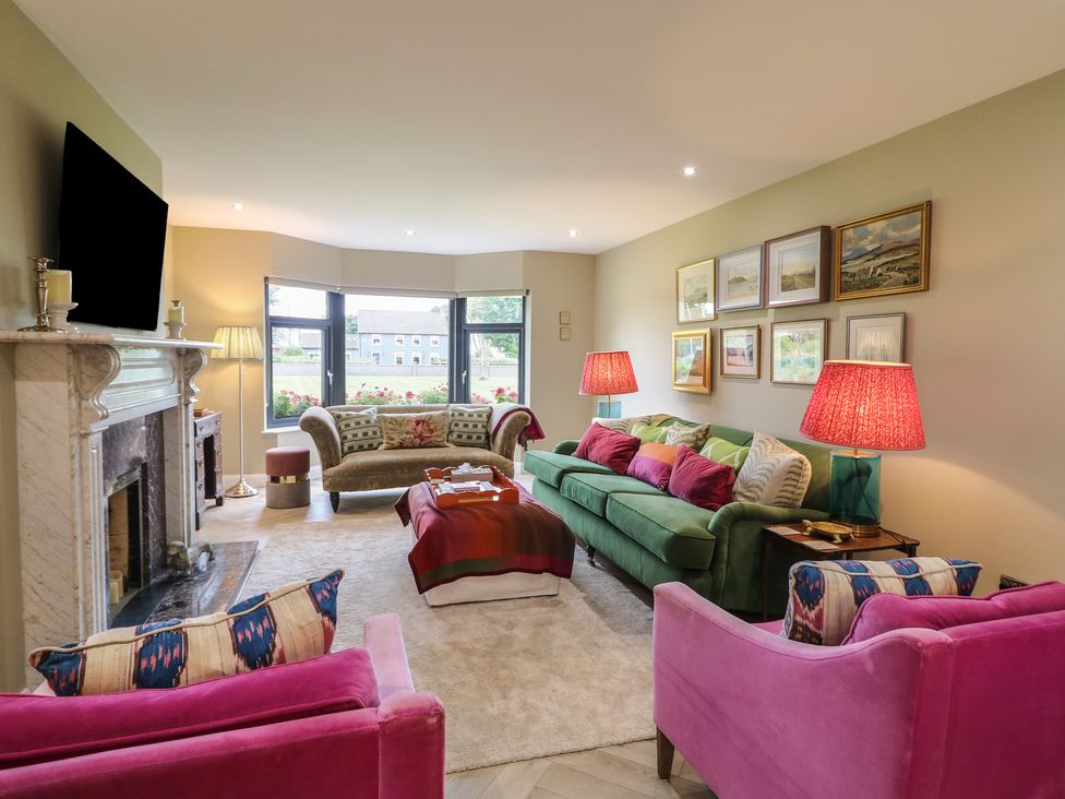 A living room with sofas and artwork at Clarmes House in Limavady