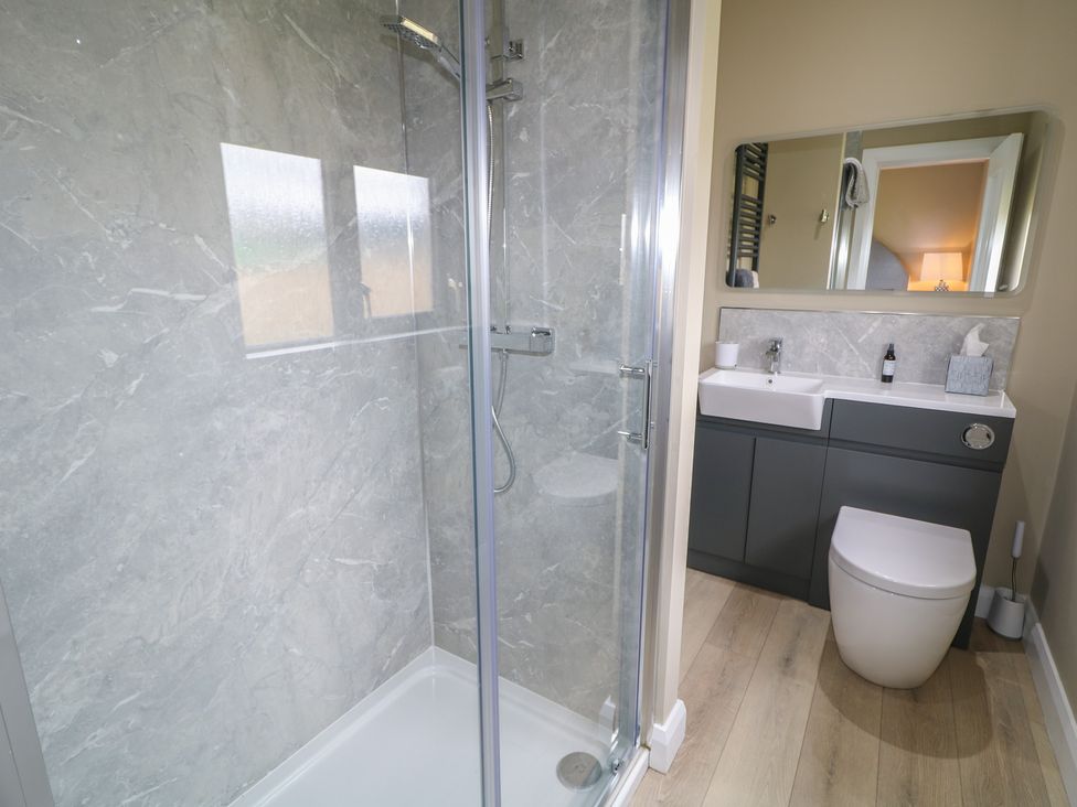 A bathroom with shower, toilet, and sink at Clarmes House in Limavady