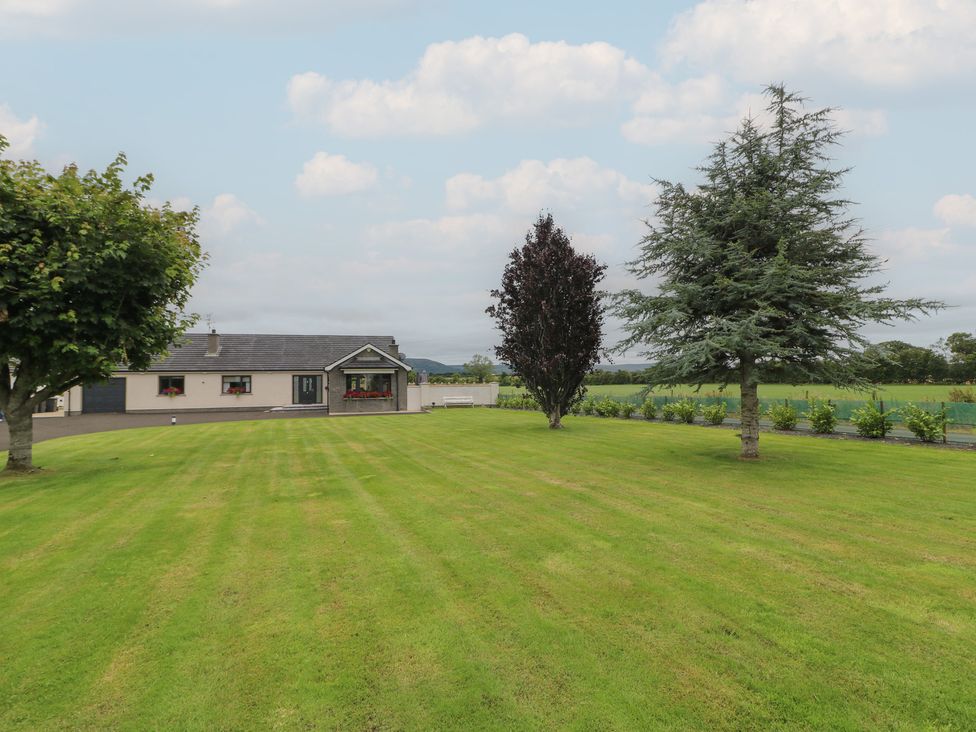 A house surrounded by trees and lawn at Clarmes House in Limavady