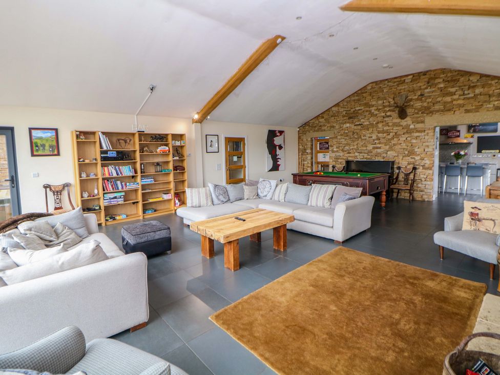 A living room with a pool table and seating at Highgate house