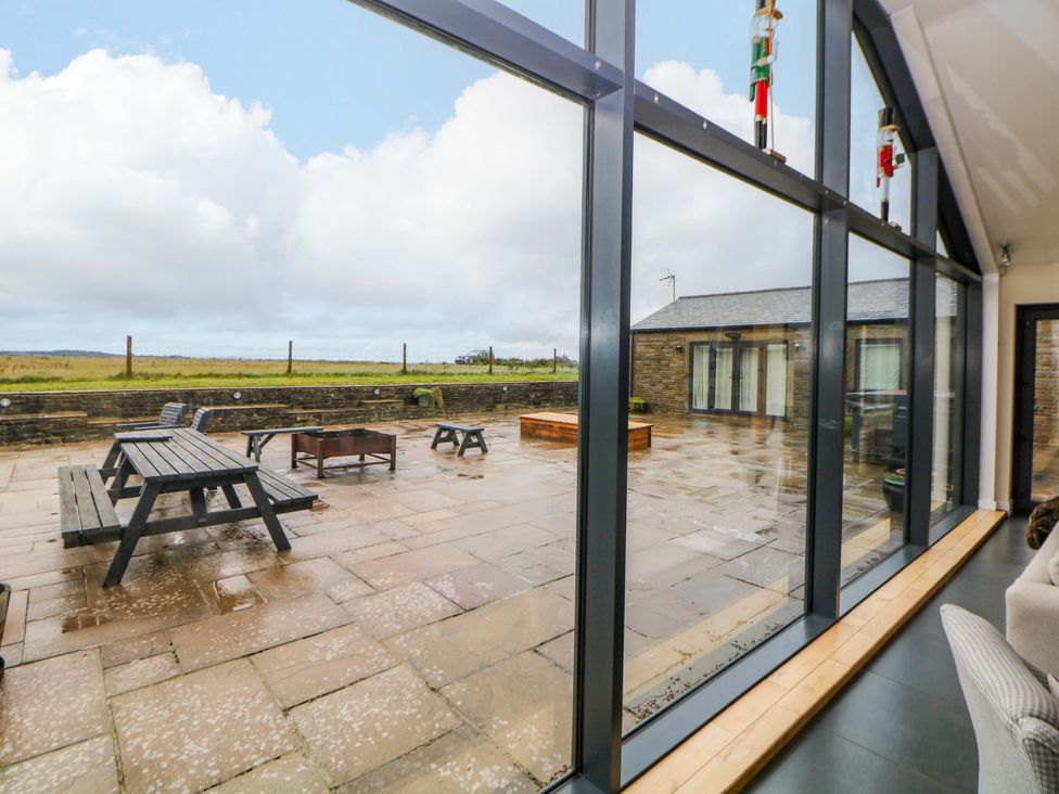 An outdoor area with seating and a fire pit at Highgate house