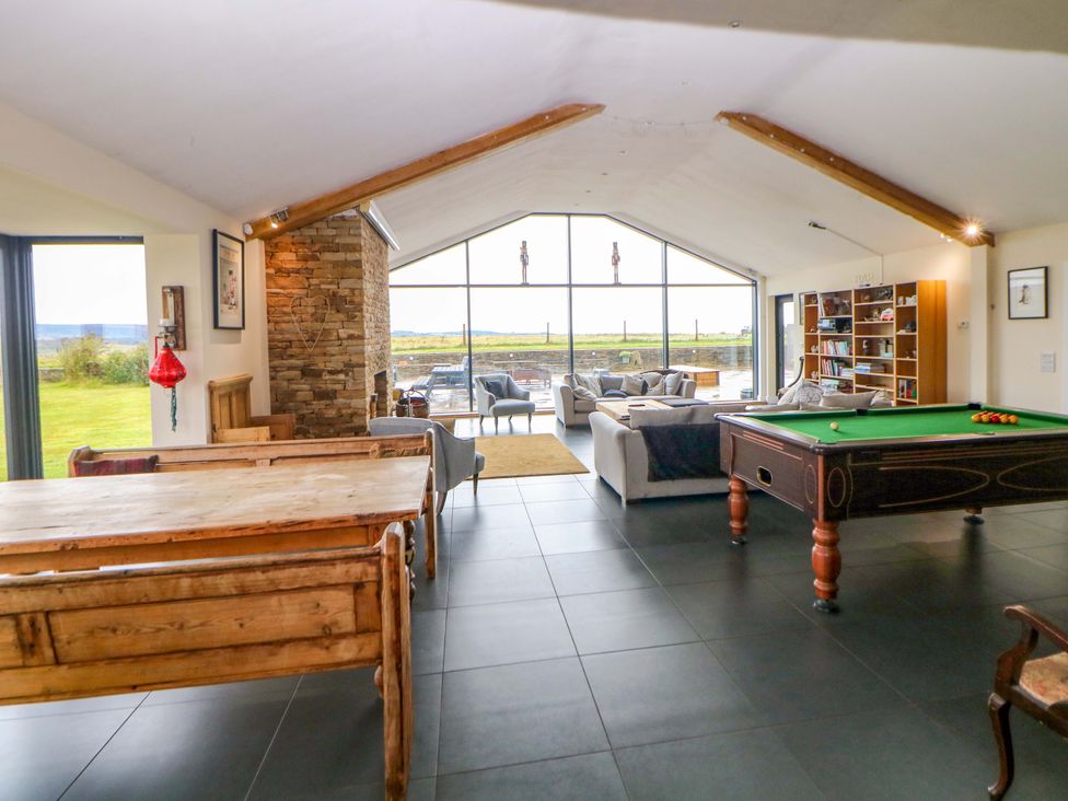 A living room with a pool table and dining table at Highgate house