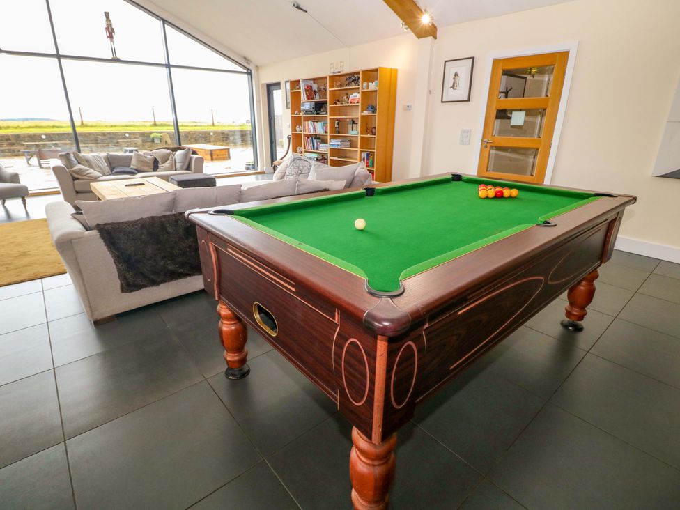 A living room with a pool table and seating area at Highgate house 