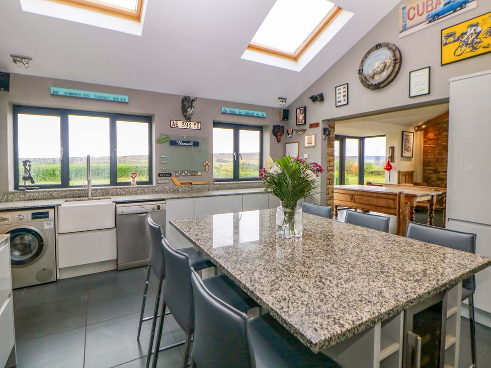 A kitchen with granite countertop and appliances at Highgate house