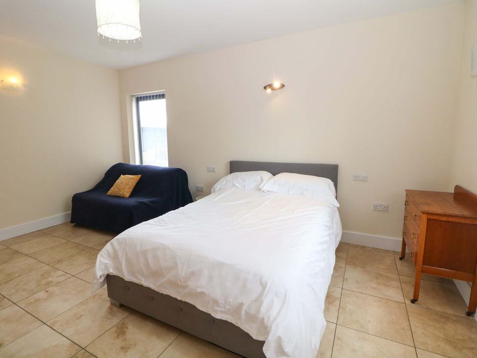 A bedroom with a bed and a sofa at Highgate house