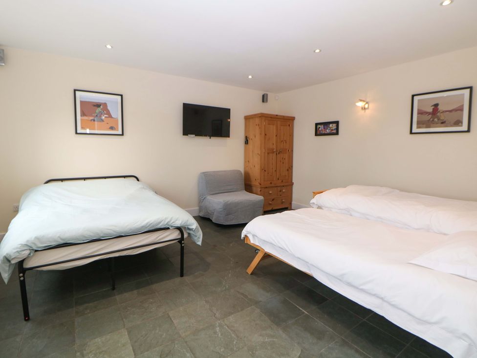 A bedroom with two beds and a wardrobe at Highgate house 
