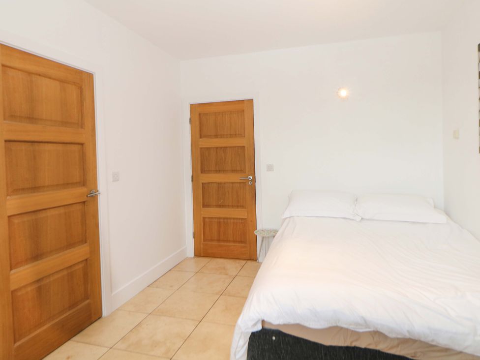 A bedroom with a bed and doors at Highgate house