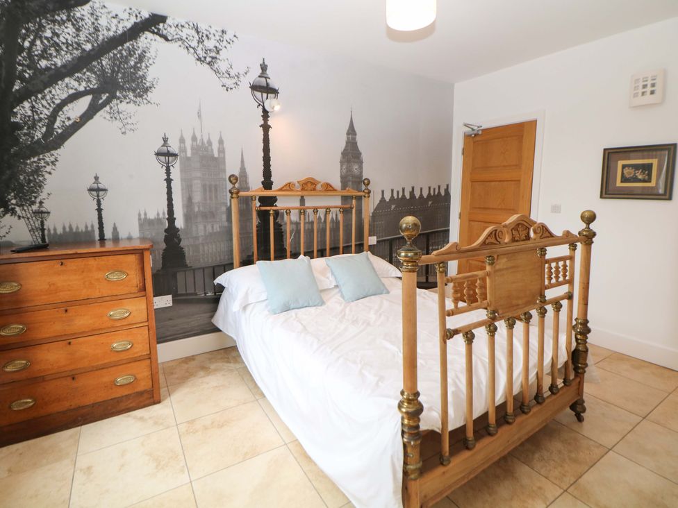 A bedroom with a wooden bed and a dresser at Highgate house
