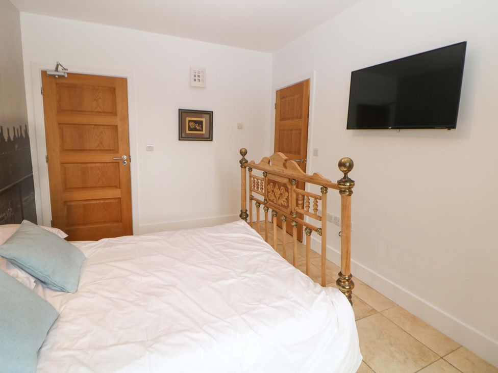 A bedroom with a bed and a television at Highgate house