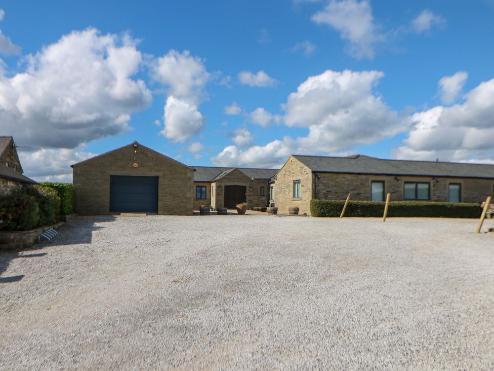 An outdoor view of a house and garage at Highgate house in Holmesfield near Dronfield