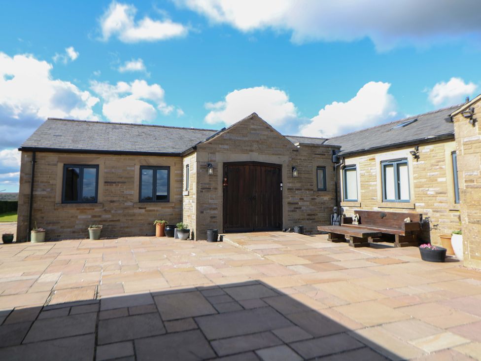 A building with a door and windows in an outdoor area at Highgate house in Holmesfield near Dronfield
