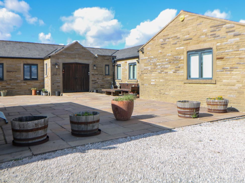 An outdoor area with stone patio and planters at Highgate house in Holmesfield near Dronfield